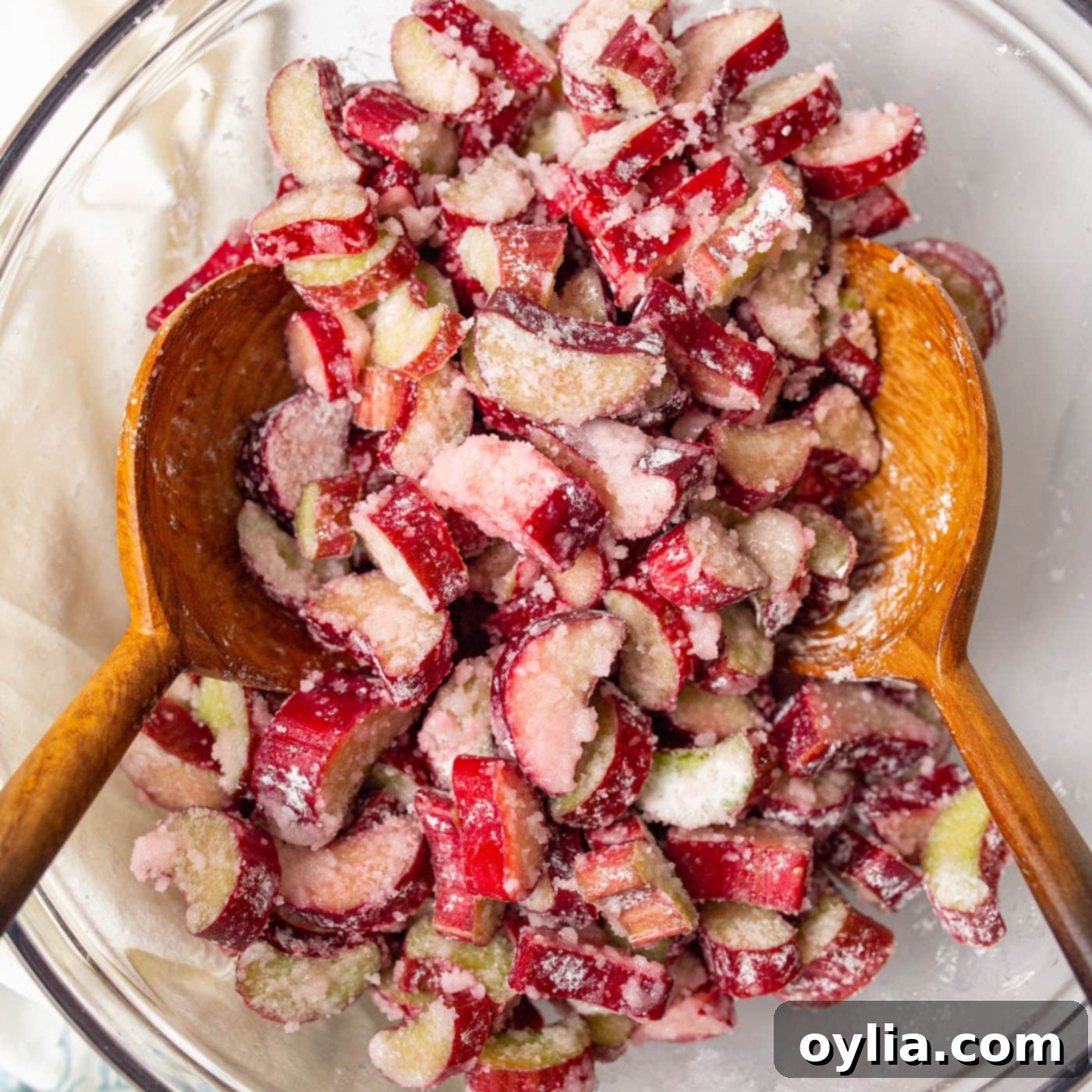 Bowl of rhubarb mixture with two wooden spoons in it