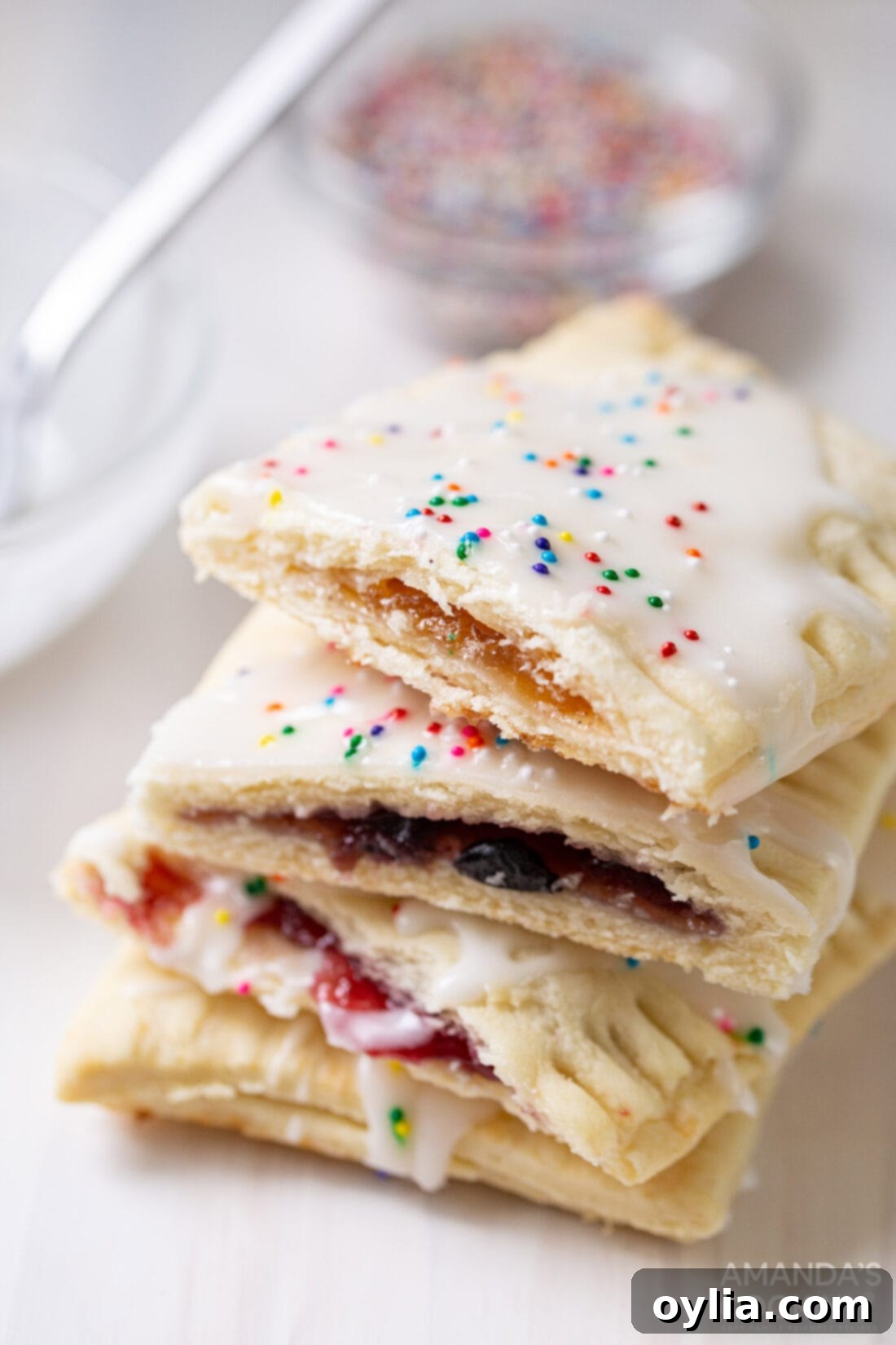 Stack of homemade pop tarts cut in half, showcasing the sweet jam filling