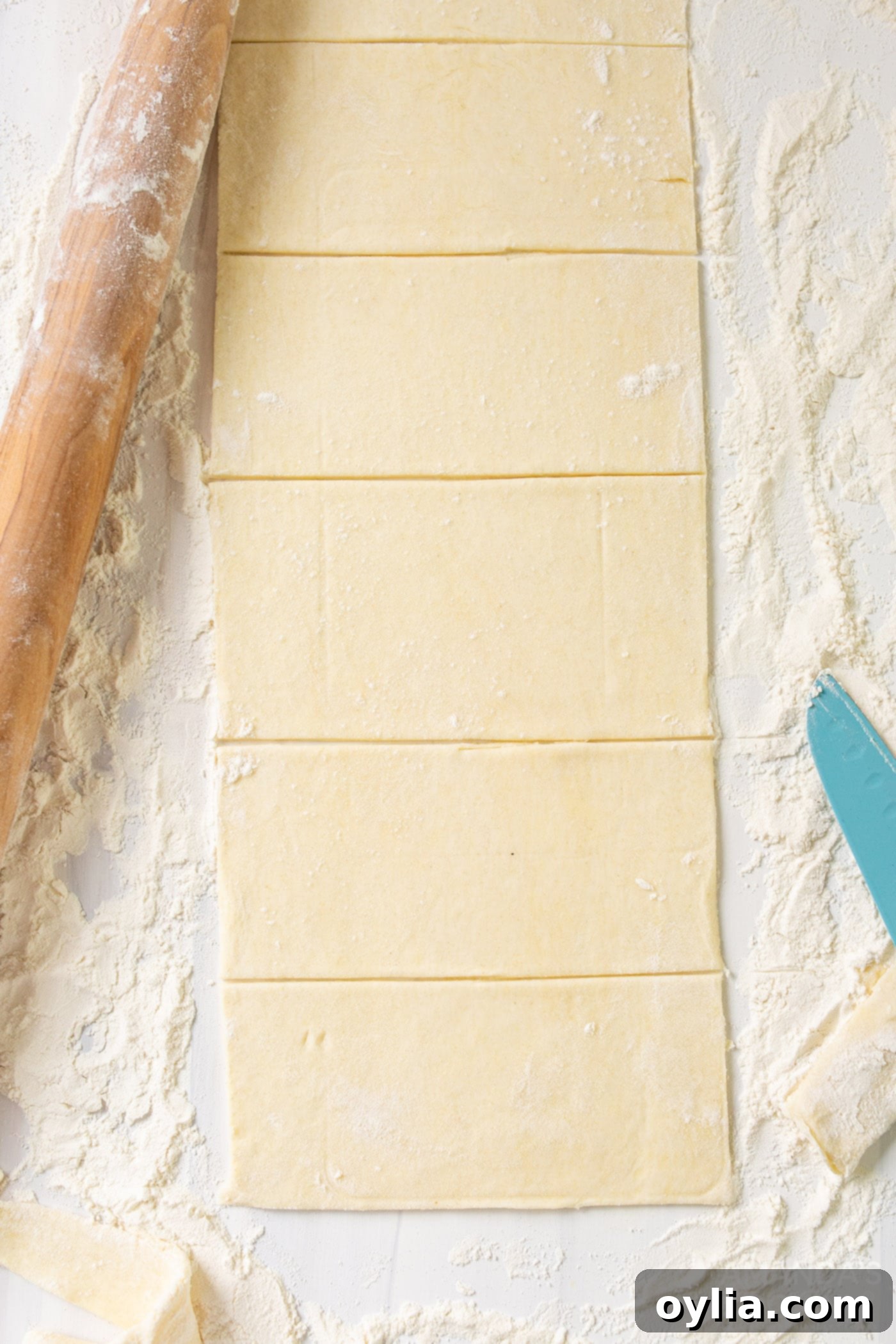 Rectangular slices of pie dough laid out on a surface, prepared for filling
