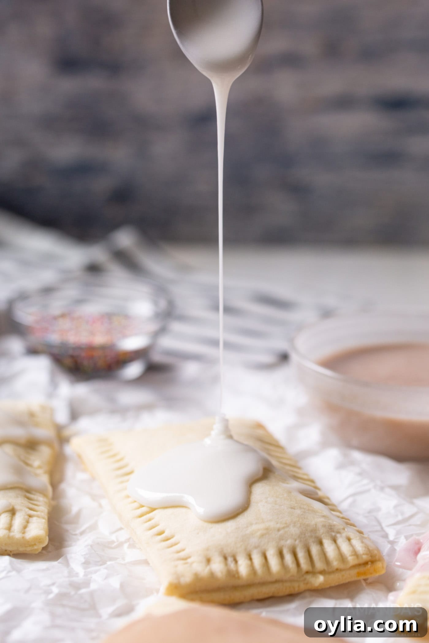 Sweet glaze being generously drizzled onto a warm homemade pop tart