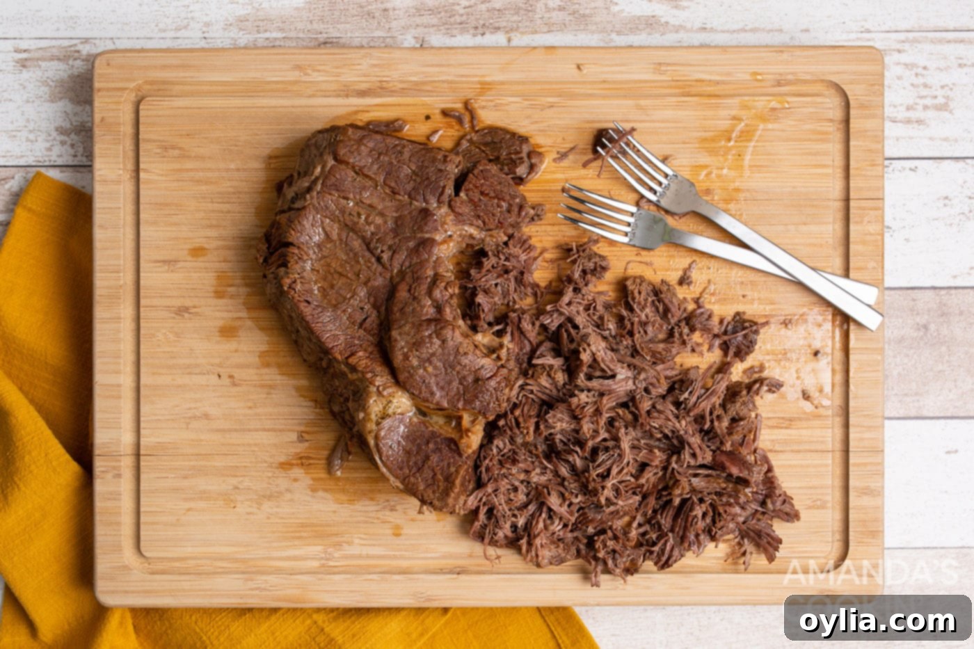 shredded chuck roast on cutting board