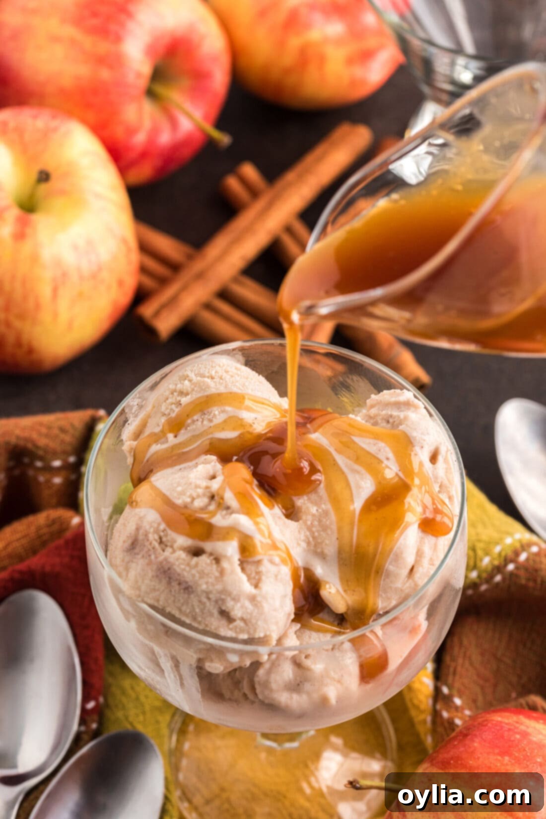 Rich caramel being drizzled artistically over perfectly scooped Apple Cider Ice Cream.