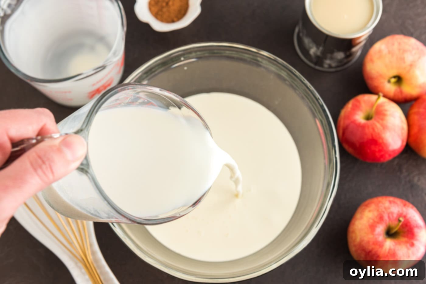 Pouring heavy whipping cream into a large mixing bowl, ready for the ice cream base.