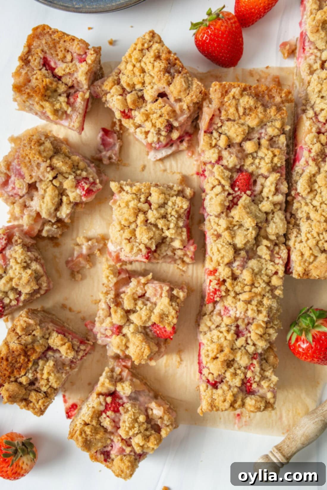 Strawberry Rhubarb Crumble Bars cut into squares, showcasing the fruit filling and crumble topping.