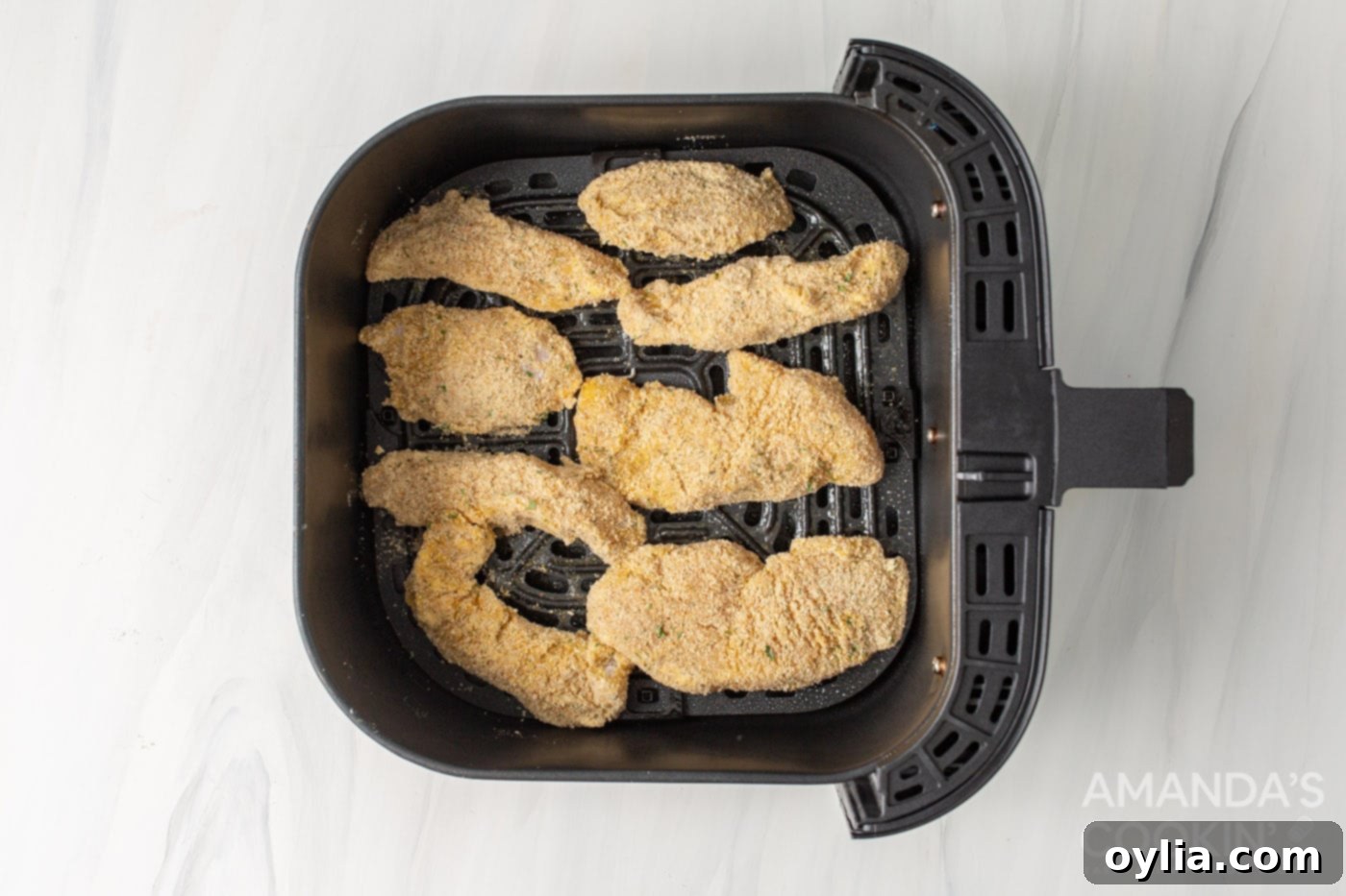 breaded chicken tenders in air fryer basket