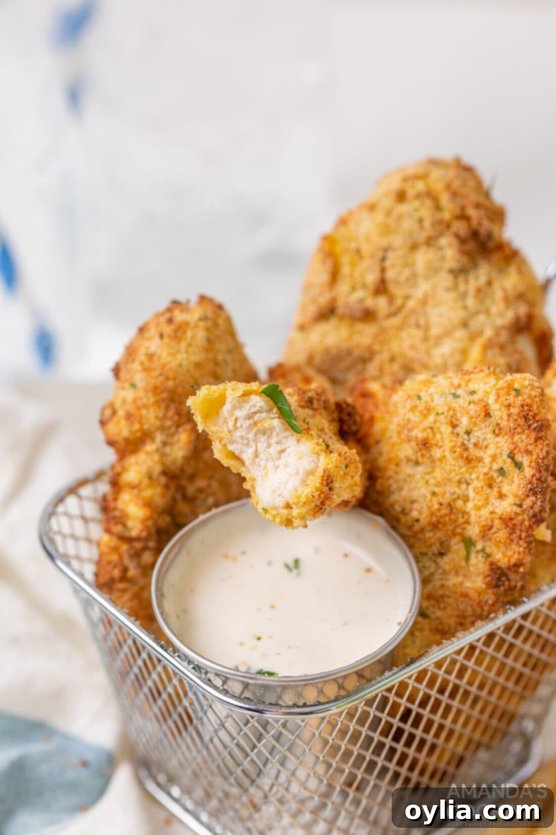 Quick and Crispy Air Fryer Chicken Tenders 9 air fryer chicken tenders in basket with ranch