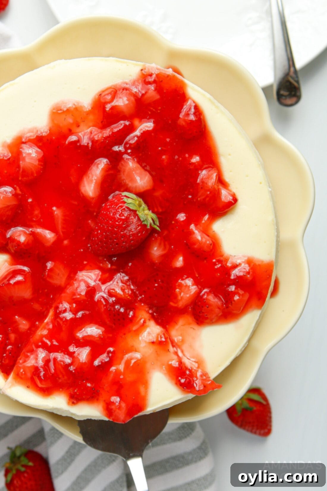 Overhead photo of a beautifully decorated Instant Pot Strawberry Cheesecake, showing the creamy texture and fresh strawberry topping.