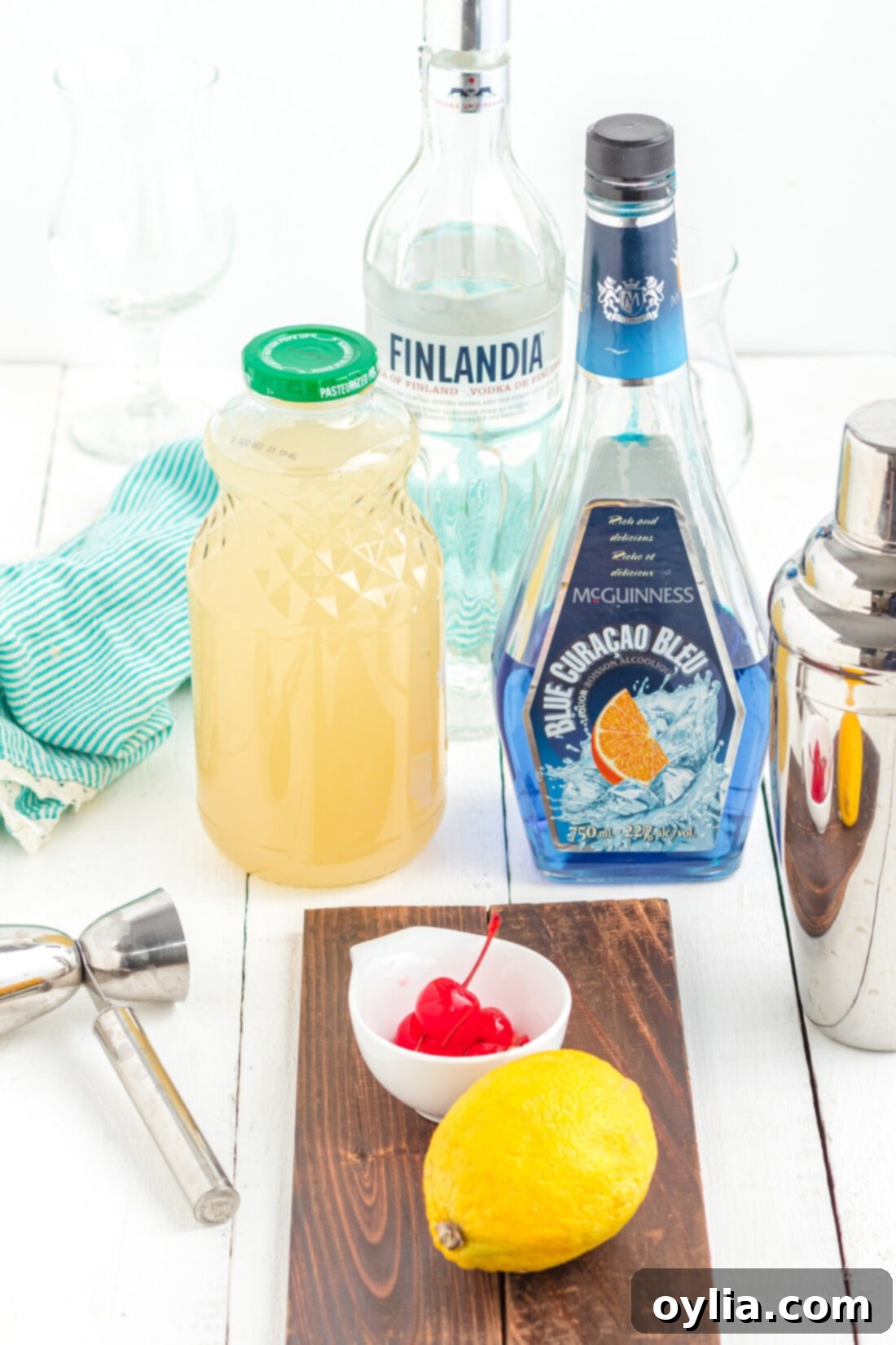 ingredients to make a Blue Lagoon Cocktail laid out on a table