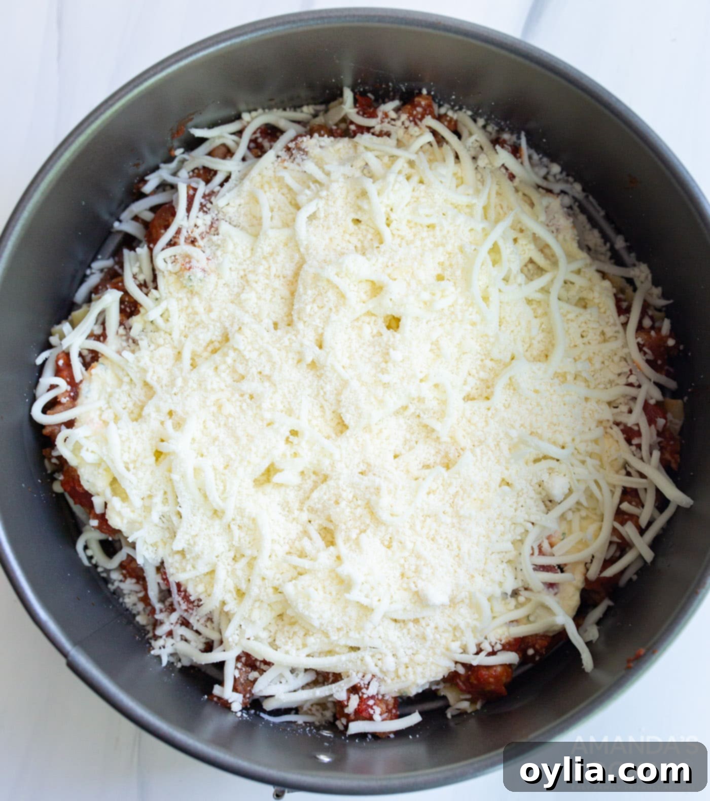 cheese on top of lasagna in springform pan