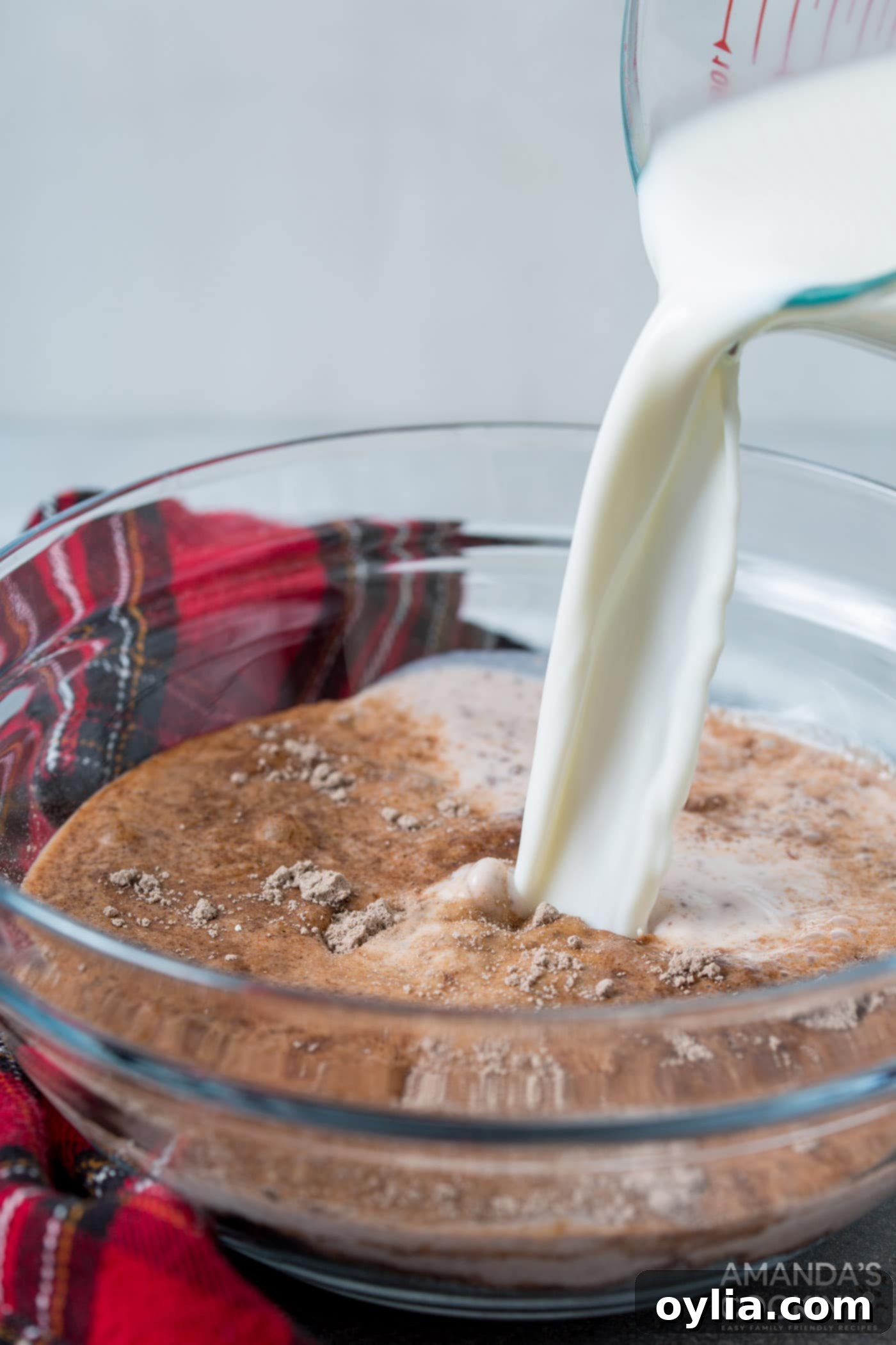 pouring milk into chocolate pudding mix