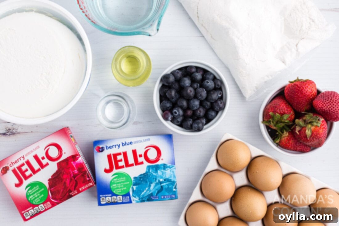 Arrangement of ingredients needed for patriotic American flag poke cake: cake mix, jello boxes, cool whip, berries