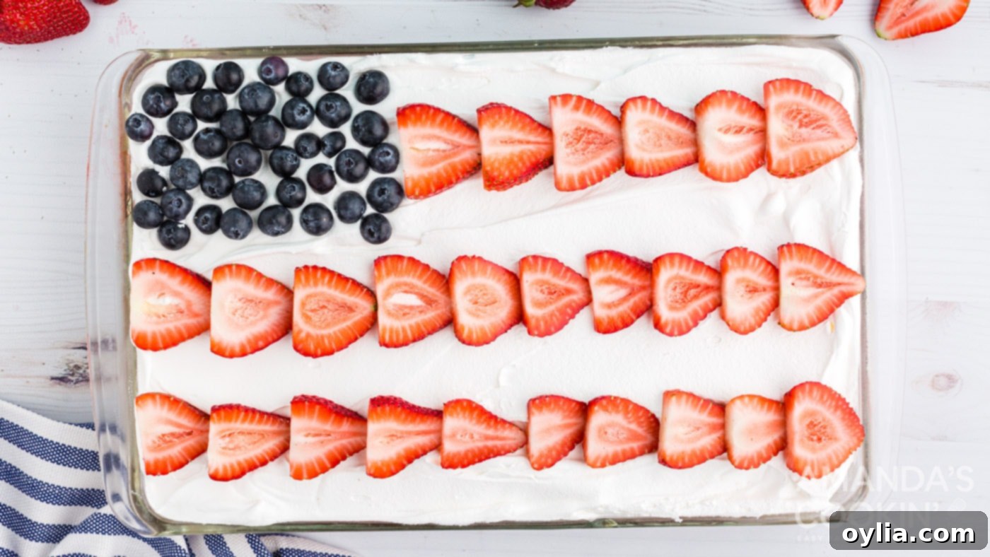 Finished poke cake decorated like an American flag with berries