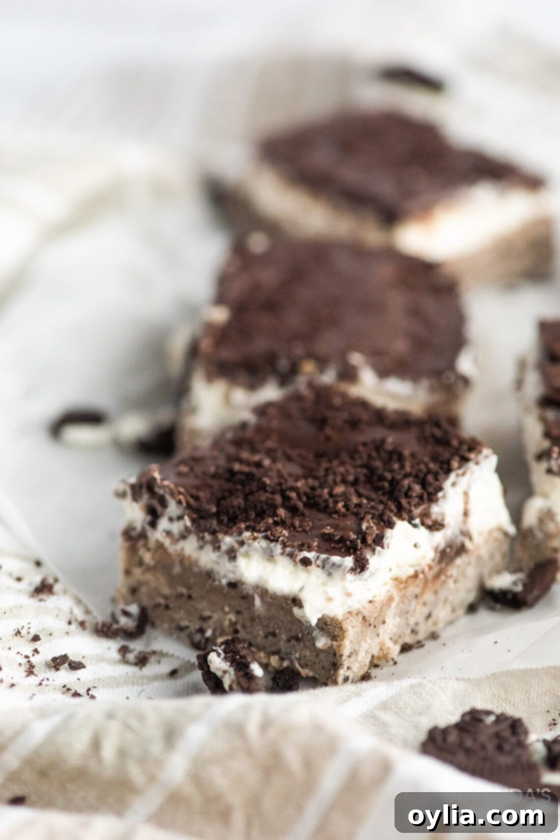 Delicious Oreo Cheesecake Bars arranged on a plate, showcasing their distinct layers