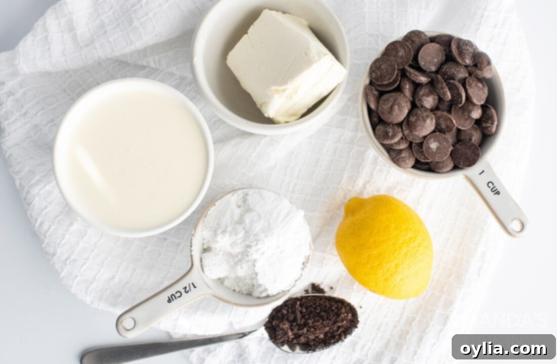 Various baking ingredients neatly arranged: flour, sugar, butter, eggs, and a block of cream cheese, all crucial for the Oreo cheesecake bars.