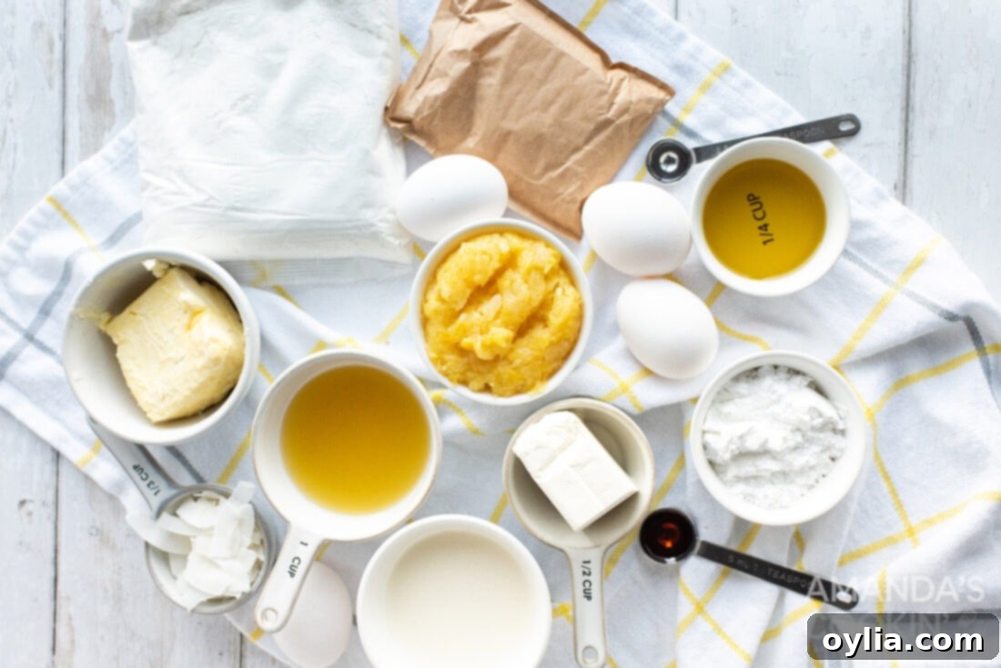 A flat lay of all the essential ingredients laid out to make a delicious Pineapple Cake, including cake mix, pineapple, coconut extract, and cream cheese.