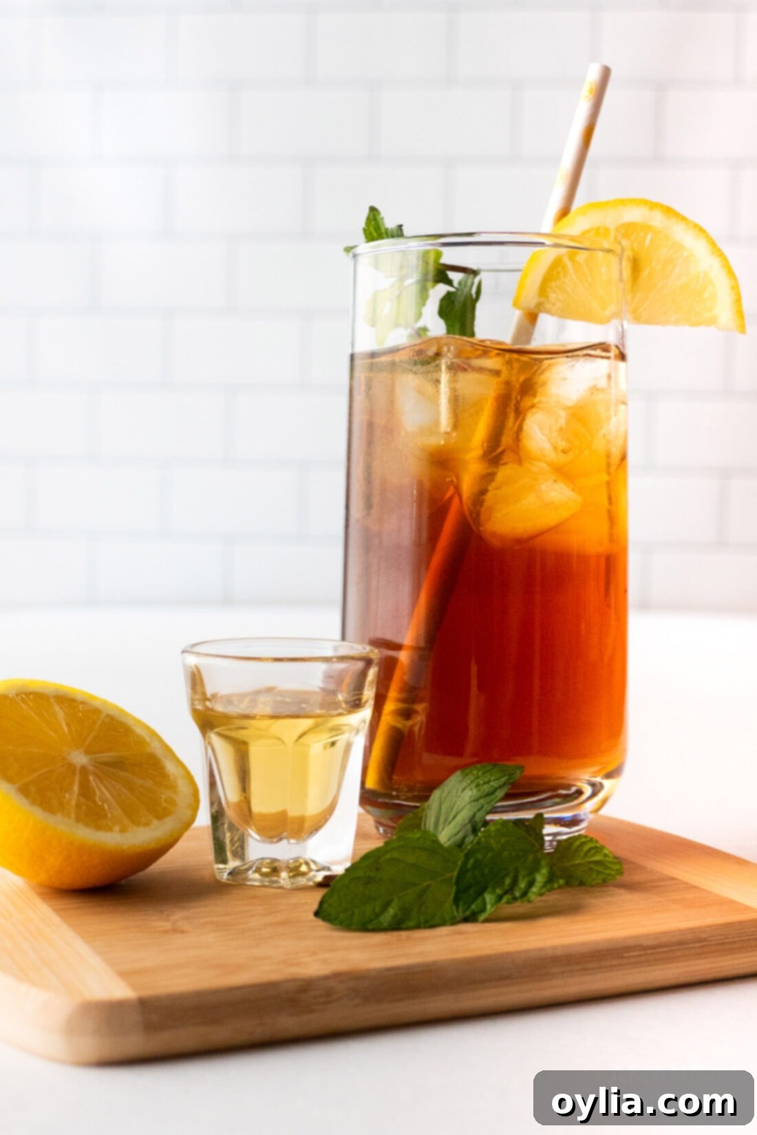Spirited Tea Cooler 2 glass of iced tea and shot of honey whiskey, representing ingredients for an iced tea cocktail