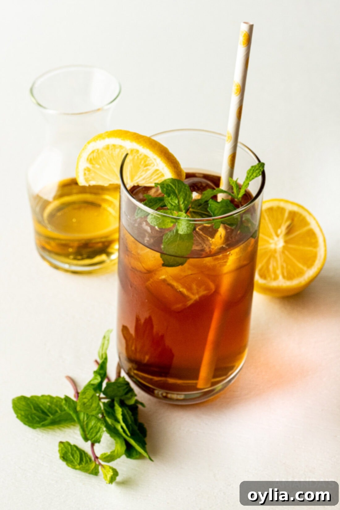 Spirited Tea Cooler 3 close-up of a refreshing iced tea cocktail garnished with lemon and mint