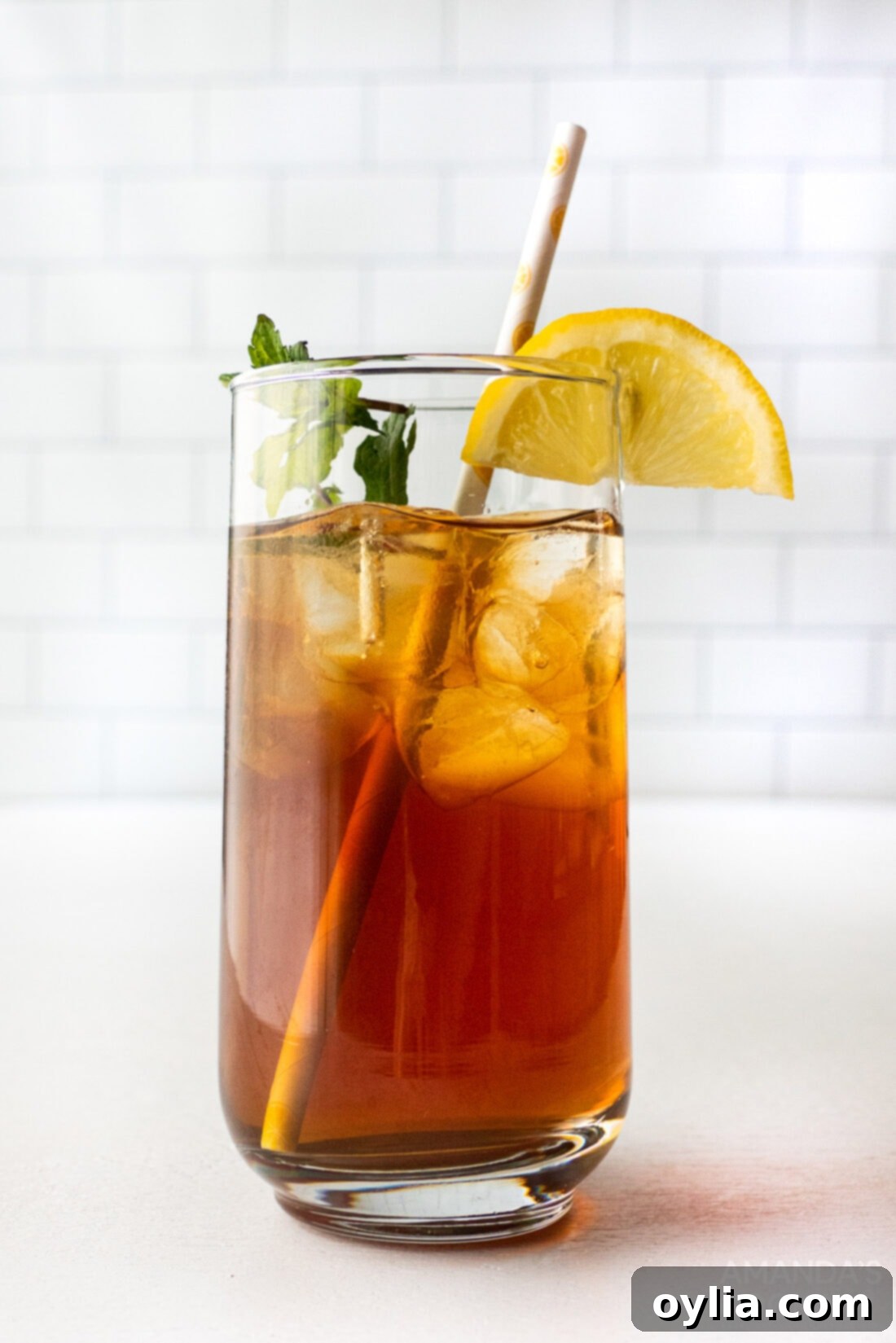 Spirited Tea Cooler 7 a perfect iced tea cocktail garnished with lemon and mint, ready to be enjoyed