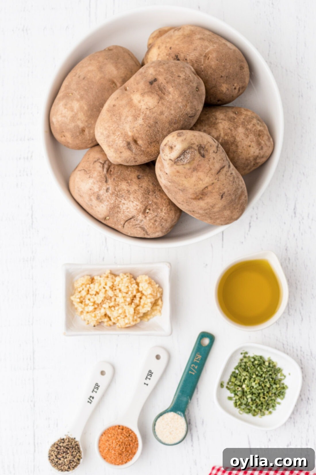 Ingredients to make Potato Wedges, including Russet potatoes, olive oil, and spices