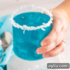 holding a glass of Ocean Water Cocktail