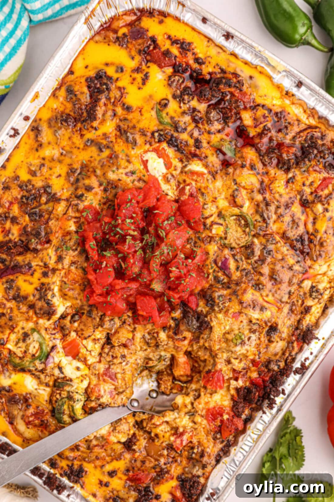 Delicious Smoked Queso Dip served hot in a foil pan, ready for dipping