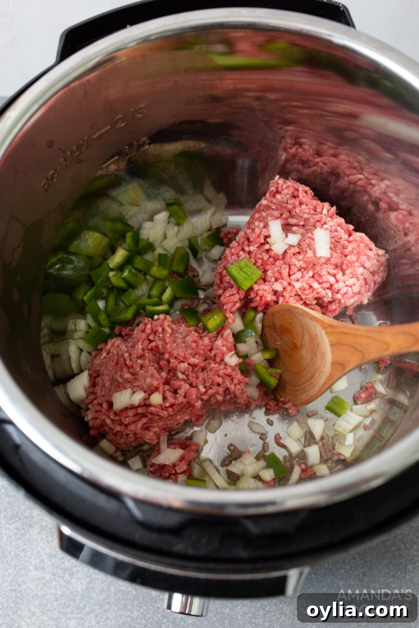 Browning ground beef, green pepper, and onion in the Instant Pot's sauté mode, creating the flavorful base for sloppy joes.