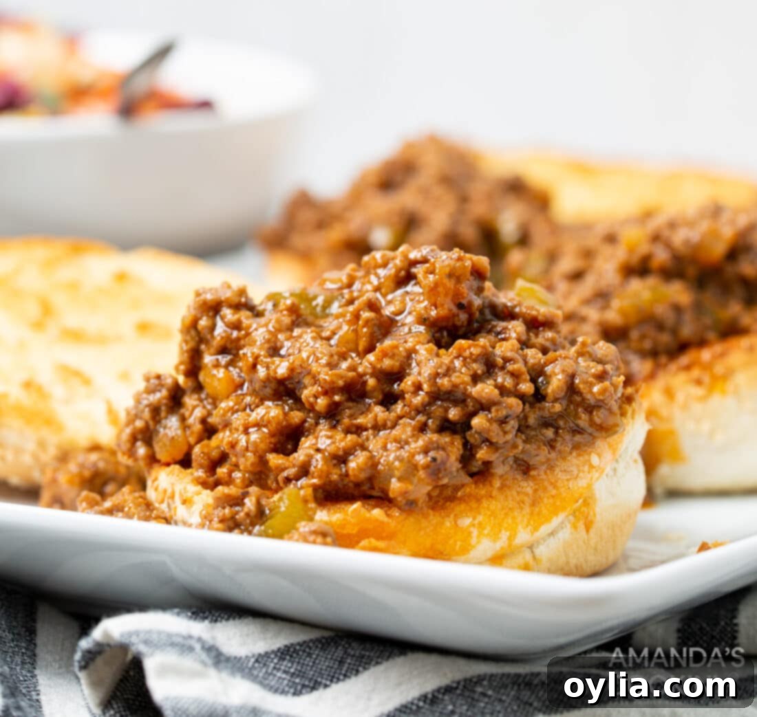 An open-faced Instant Pot Sloppy Joe sandwich, showing the generous, saucy meat filling.