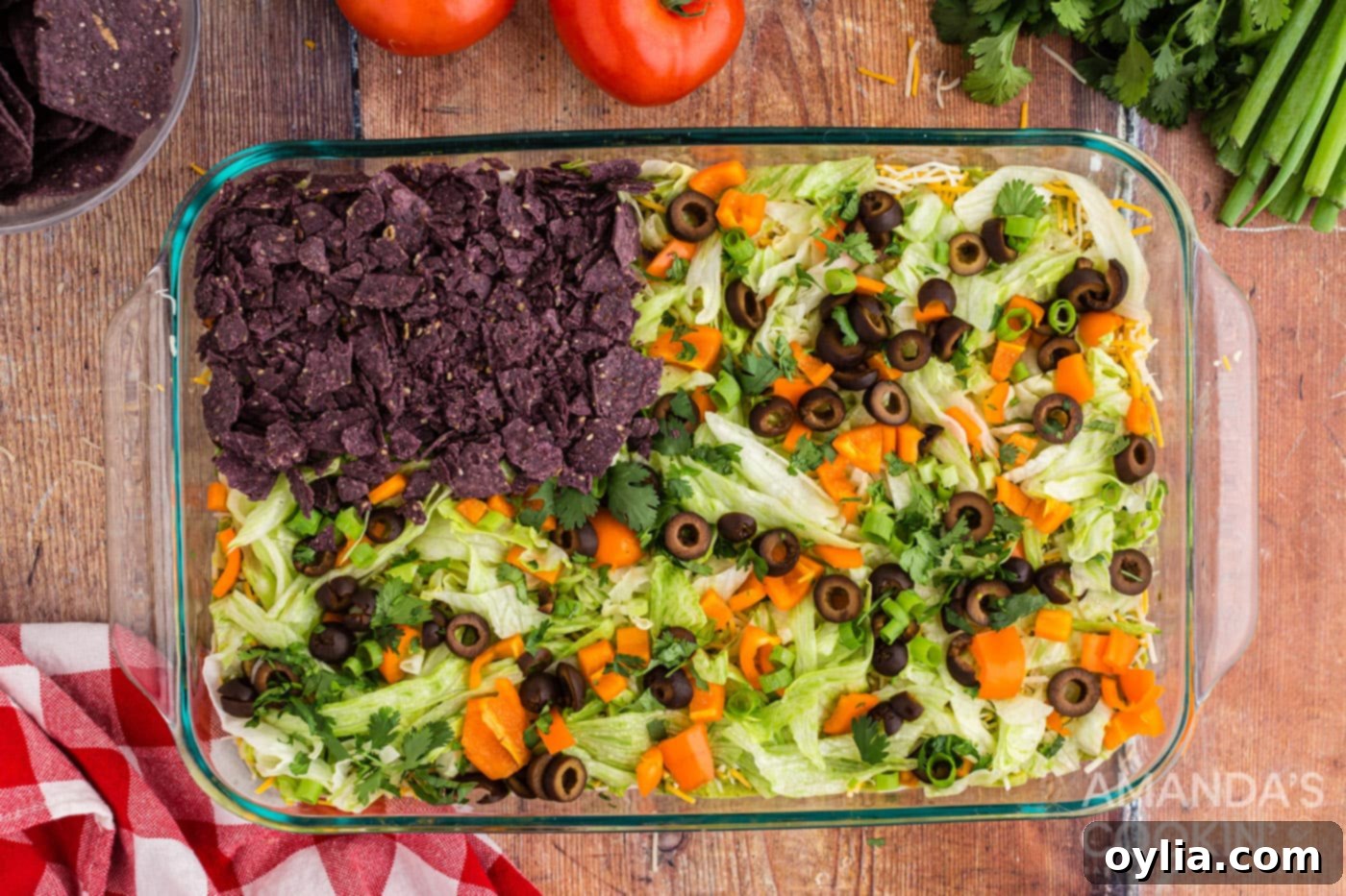 Crushed blue tortilla chips strategically placed in the upper left-hand corner of the taco dip, forming the blue field of the American flag design.