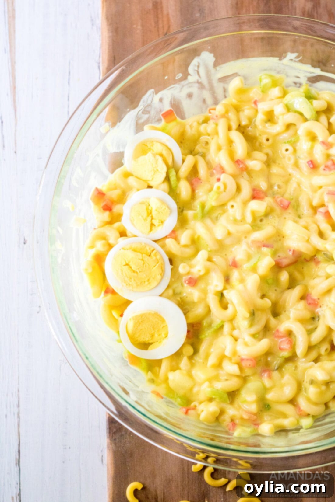 bowl of Amish Macaroni Salad garnished with boiled egg slices