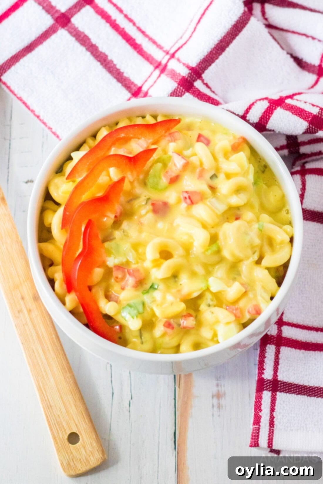small bowl of Amish Macaroni Salad garnished with red bell pepper