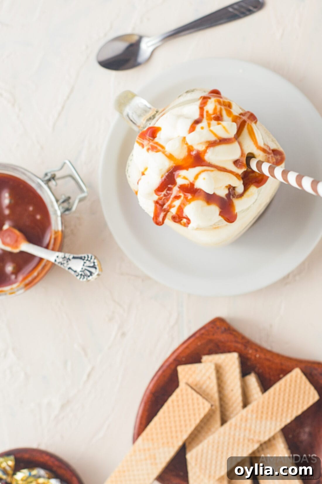 An overhead shot of a beautifully garnished salted caramel milkshake, showing off its rich color and creamy texture.