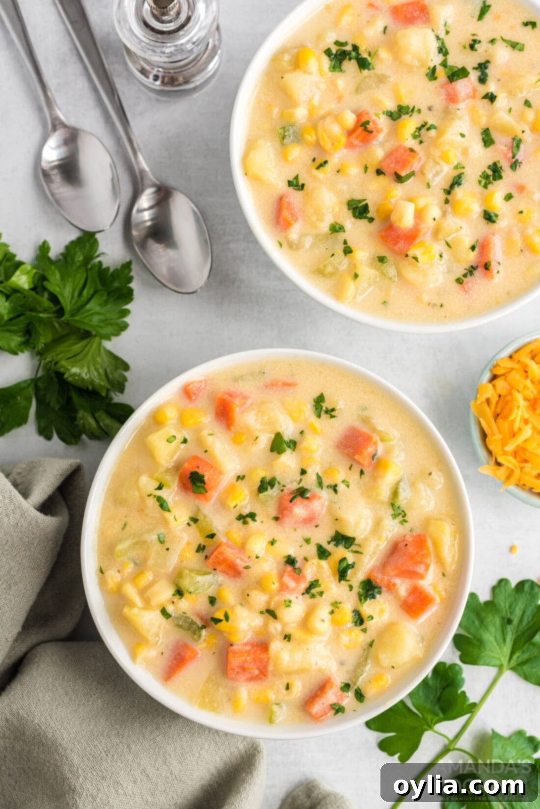 Sunshine Corn Chowder 10 Two cozy bowls of creamy corn chowder, ready to be served.