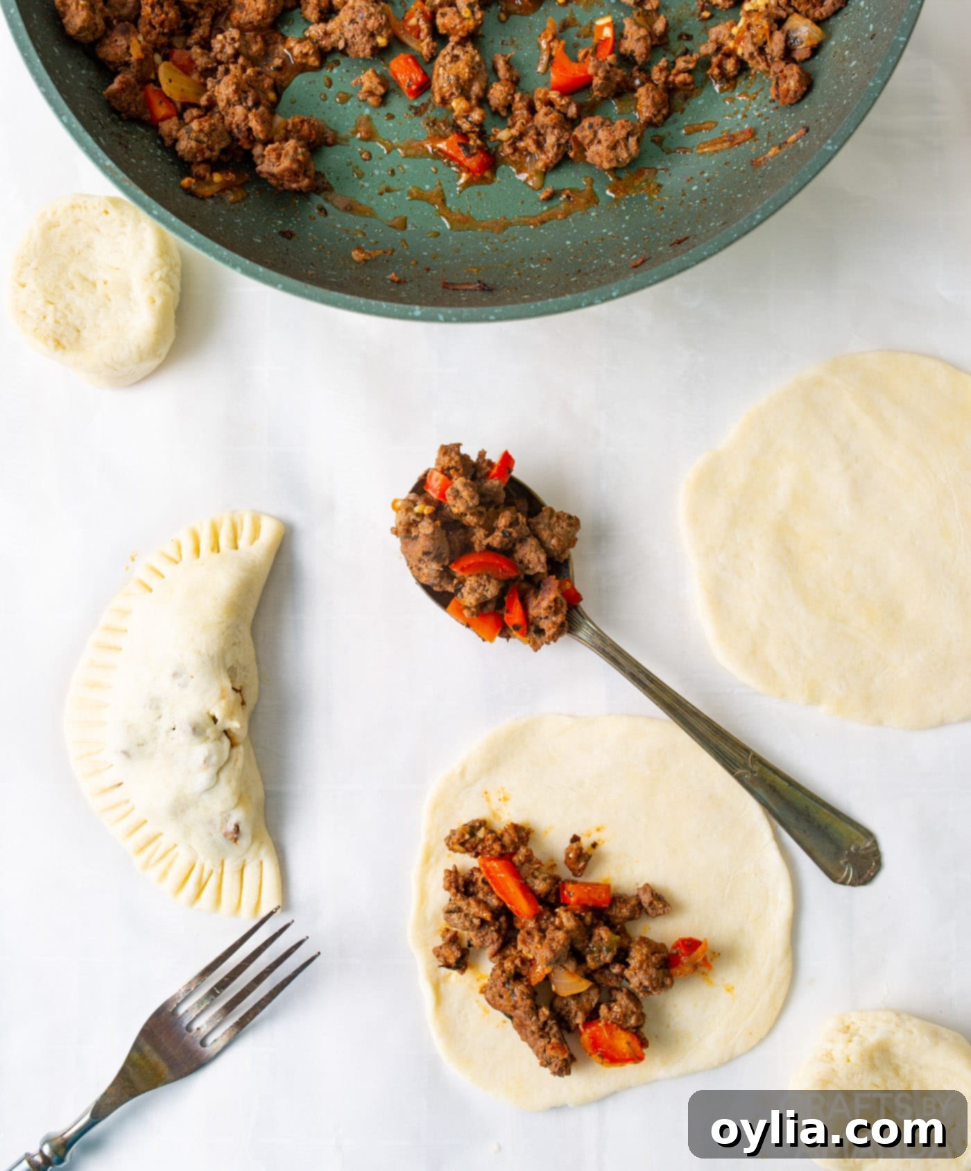 filling pie dough discs with ground beef mixture