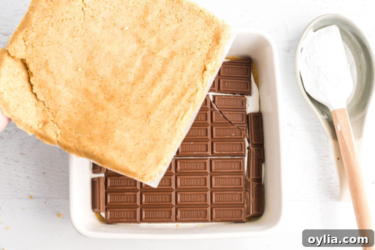 placing chocolate bars on top of marshmallow layer