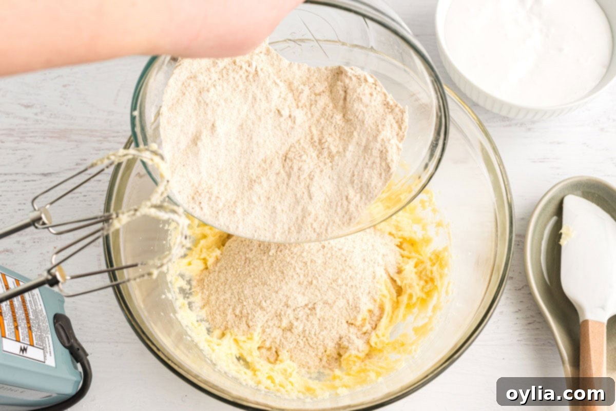 adding graham cracker mixture to butter mixture