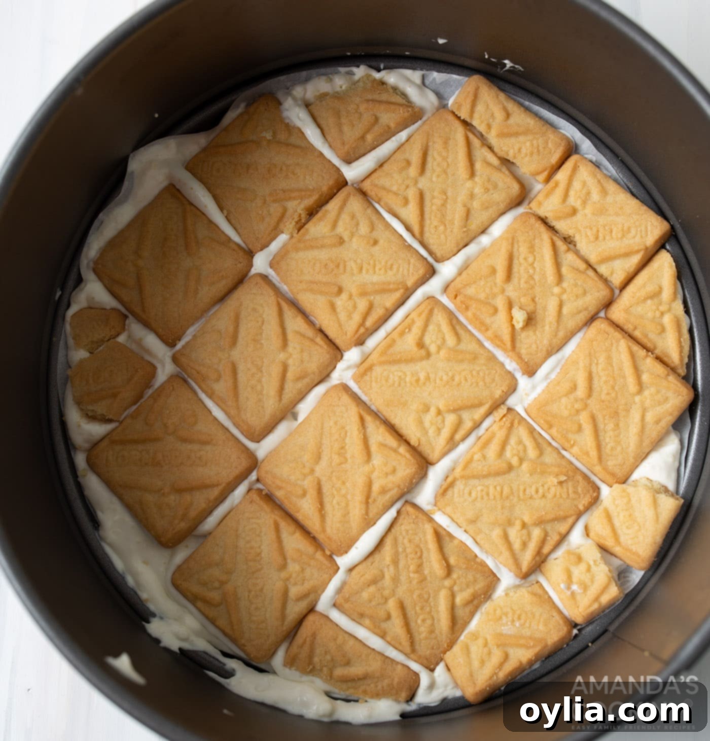 layer of pudding mixture and shortbread cookies in a springform pan