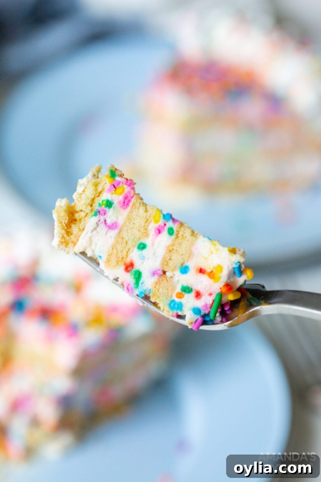 No-Bake Rainbow Sprinkle Delight 9 fork taking a bite of Funfetti Icebox Cake