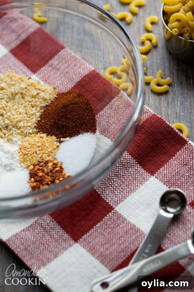 A bowl filled with a variety of colorful chili spices and seasonings, ready to be blended into a homemade chili seasoning mix.