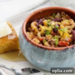 Chili Mac served in a bowl, with a side of cornbread, highlighting a warm and satisfying meal.