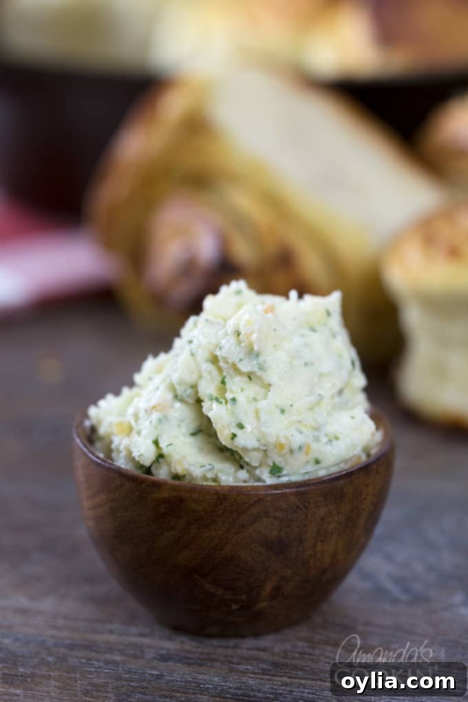 A close up of a wooden bowl filled with a rich, aromatic homemade garlic butter.