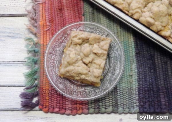 An overhead photo of a piece of crumb cake on a clear plate.