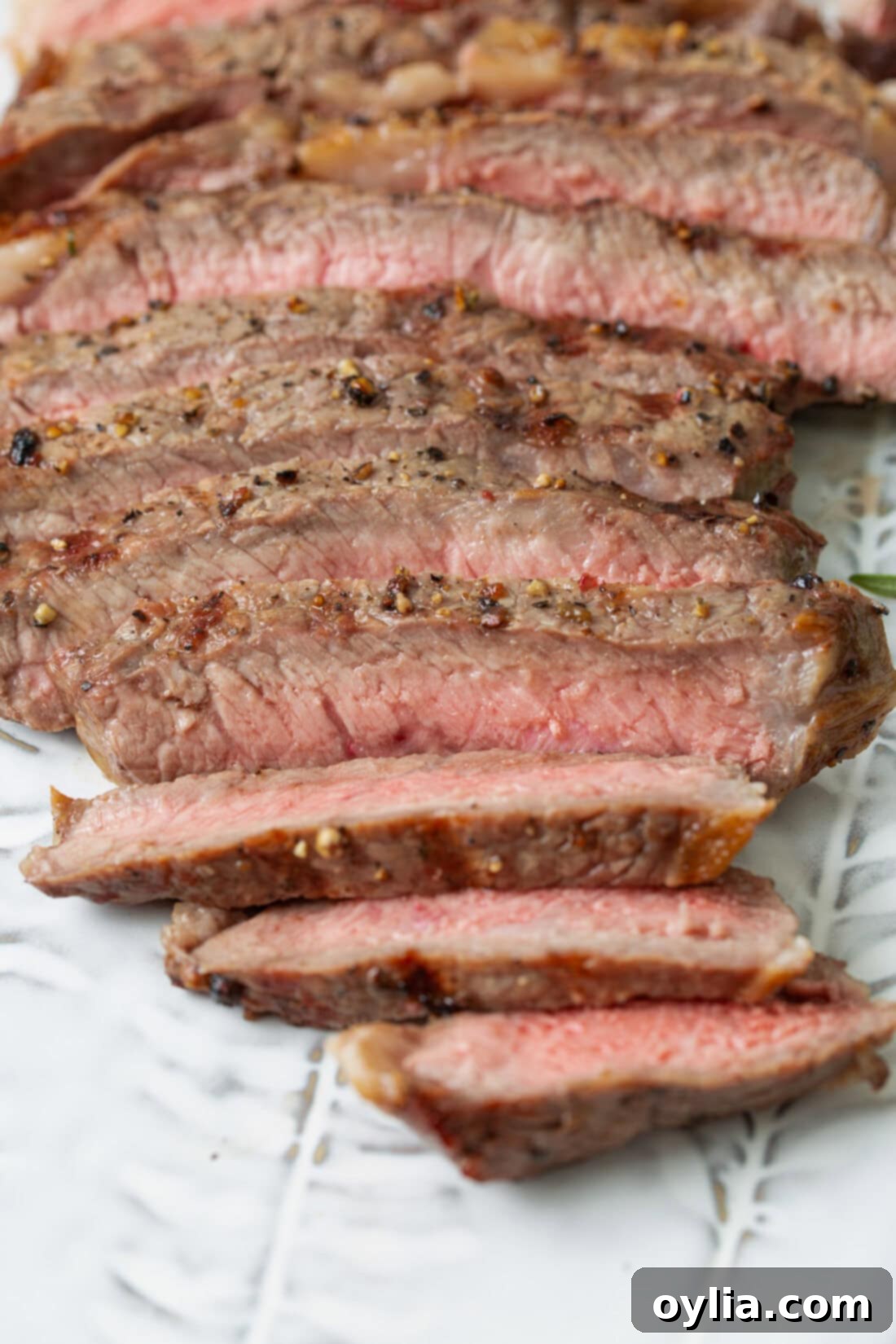 Sizzling Steak Perfection 2 Sliced Grilled Steak, revealing a perfectly cooked medium-rare interior.