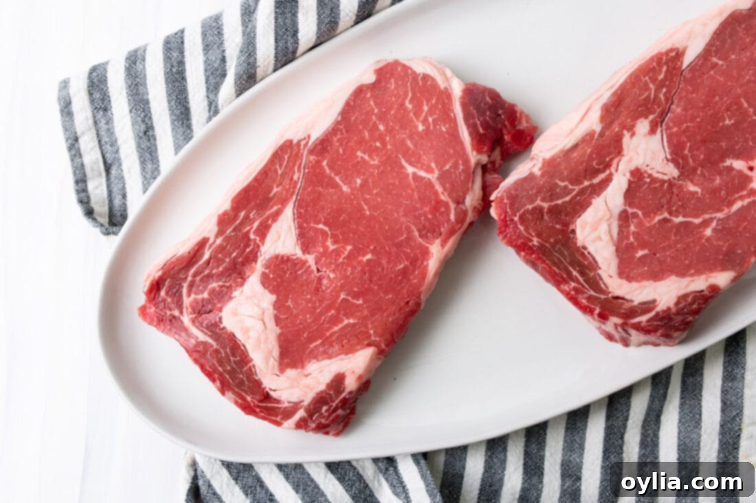 Sizzling Steak Perfection 4 Ingredients for Grilled Steak: raw steaks, coarse salt, coarse pepper, and butter.