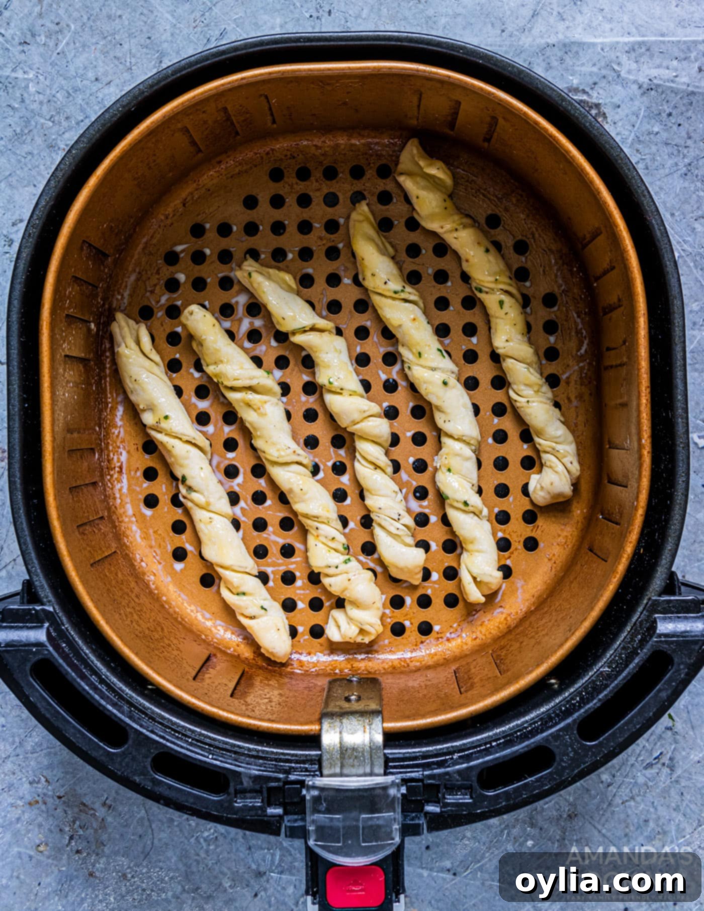 garlic parmesan twists cooking in air fryer basket
