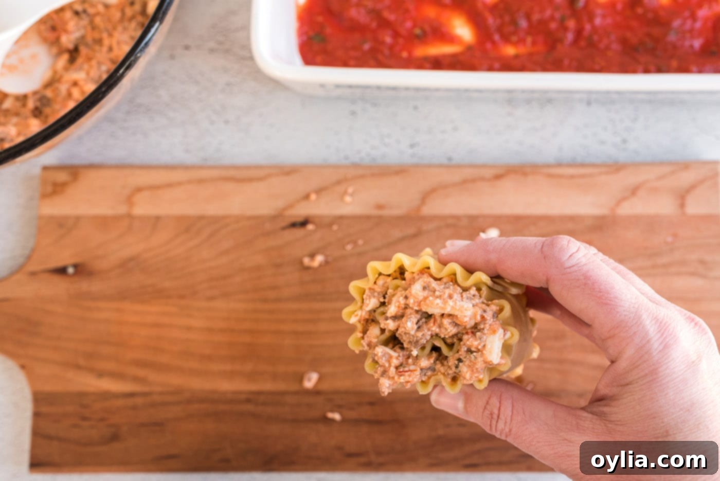 hand holding lasagna roll up