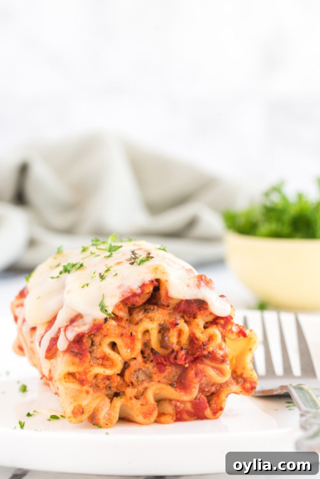 Lasagna Roll Up with a fork on a plate
