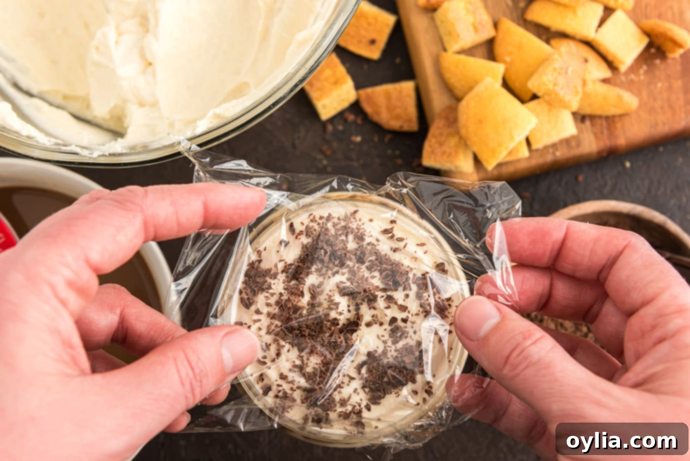 covering Bailey's tiramisu parfaits with plastic wrap