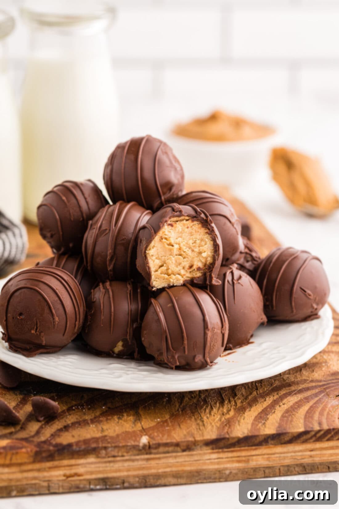 Sweet & Salty Peanut Butter Chocolate Delights 2 A plate full of beautifully coated No-Bake Chocolate Peanut Butter Balls, drizzled with chocolate