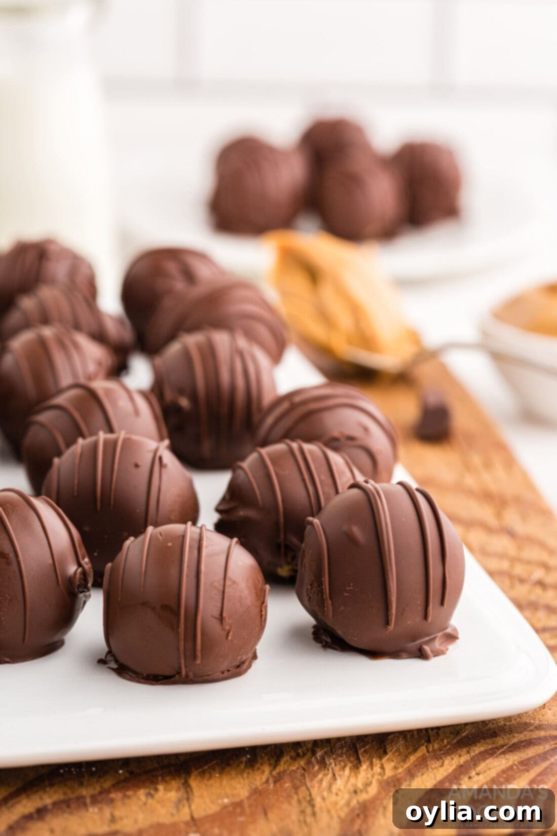 Sweet & Salty Peanut Butter Chocolate Delights 13 White cutting board displaying a beautiful arrangement of Chocolate Peanut Butter Balls