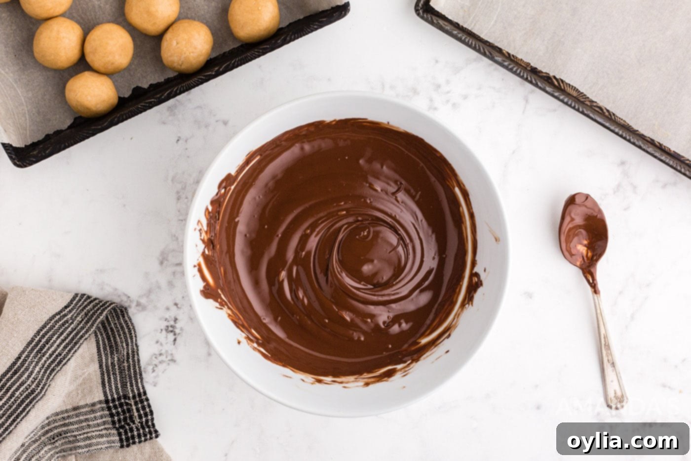 Melted semi-sweet chocolate and shortening in a bowl, smooth and ready for dipping